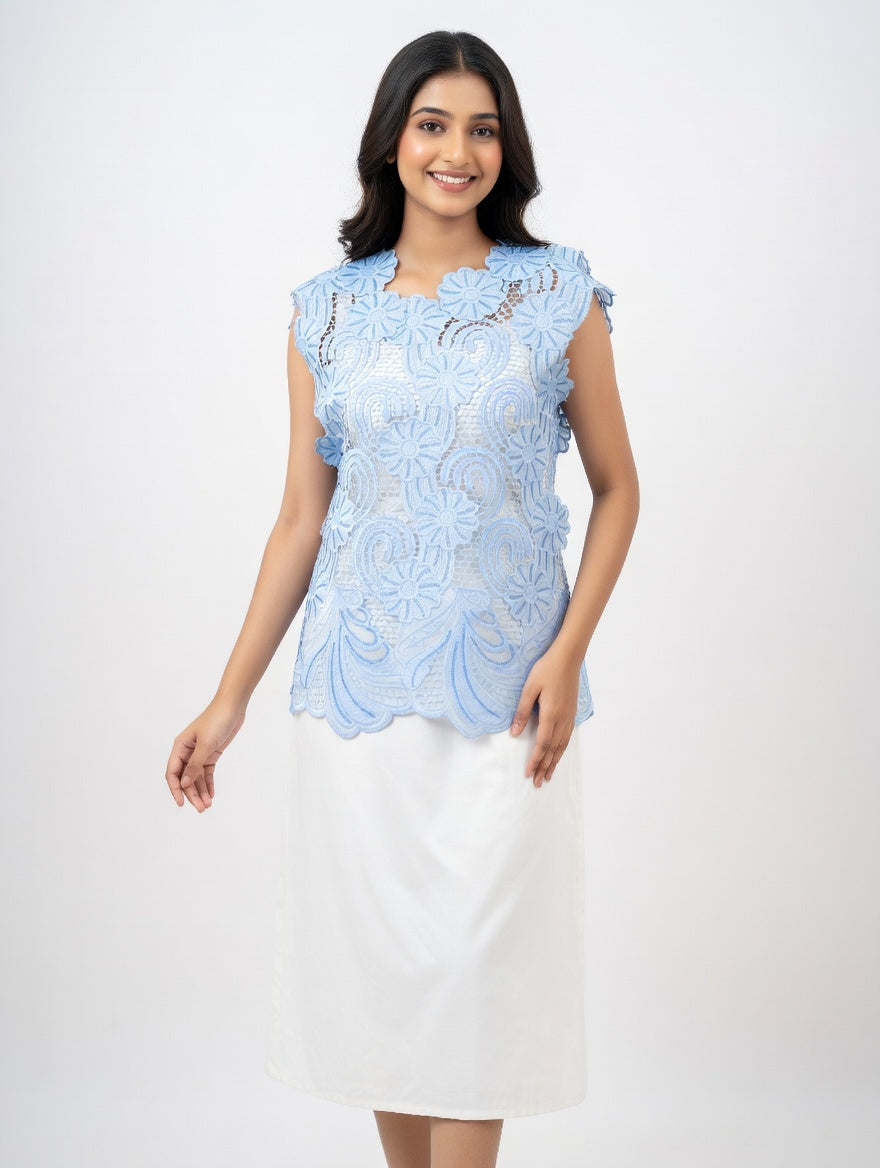 a light blue embroidered cutwork top with side ties and subtle sequin accents