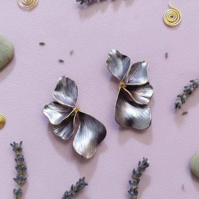 A pair of Purple half floral-shaped metal flower earrings