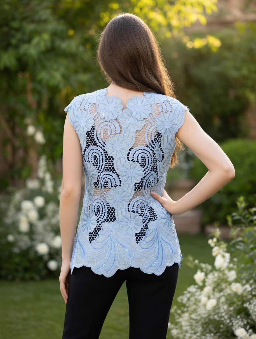 Back View of light blue embroidered cutwork top with side ties and subtle sequin accents