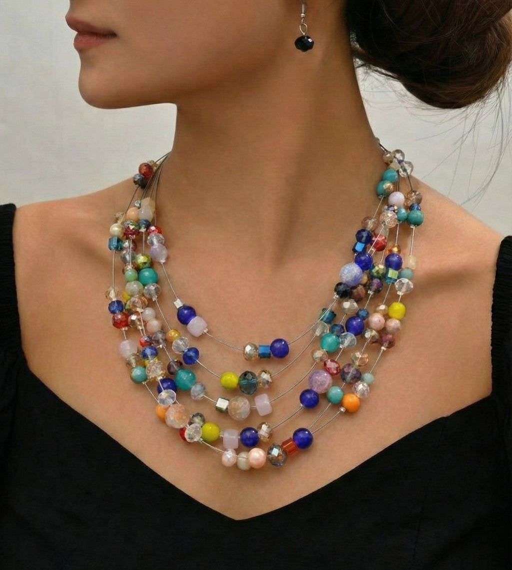 Bohemian-style layered necklace with mismatched beads in blue, yellow, and turquoise on silver-tone wires