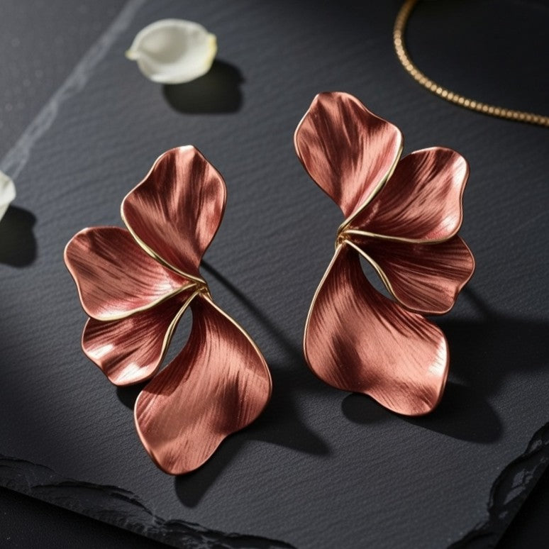 Brushed copper floral earrings on black slate
