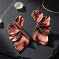 Brushed copper floral earrings on black slate