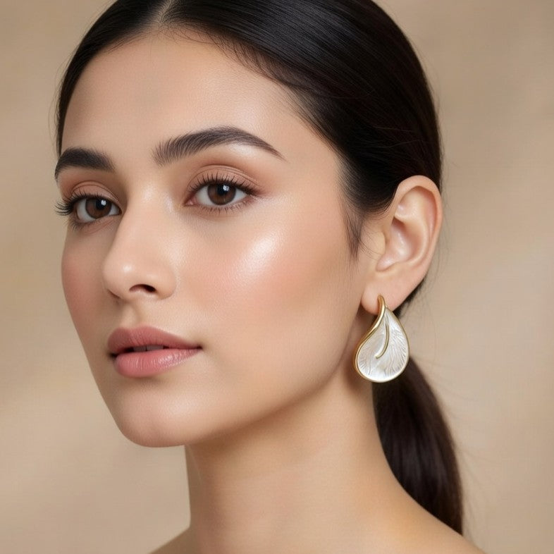 Close-up of Kurly Wurly white and gold organic statement earring