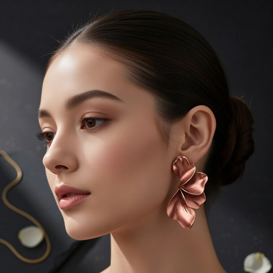 Close-up of sculptural copper and gold petal earrings
