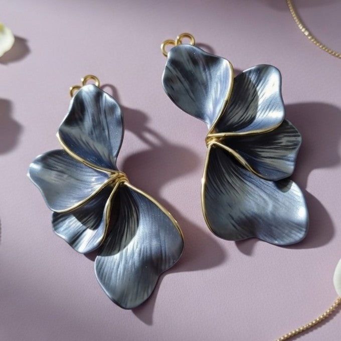Detailed close-up of textured silver ginkgo leaf dangle earrings