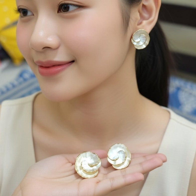 Detailed close-up shot of the Petal-Scalloped Pearlescent Gold Statement Studs, highlighting the overlapping gold-plated petals and the intricate pearlescent texture