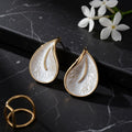 Elegant gold-plated botanical earrings with a textured pearl finish