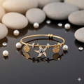Gold charm bracelet featuring a central starfish with an evil eye, gold seashells, and white pearls