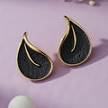 Leaf-shaped gold-plated stud earrings with a textured black inlay