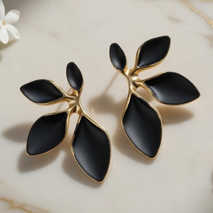 Modern botanical branch stud earrings with 18K gold-plated edges.