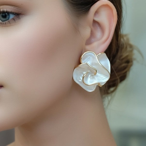 Pearlescent white metal rose earrings with gold borders
