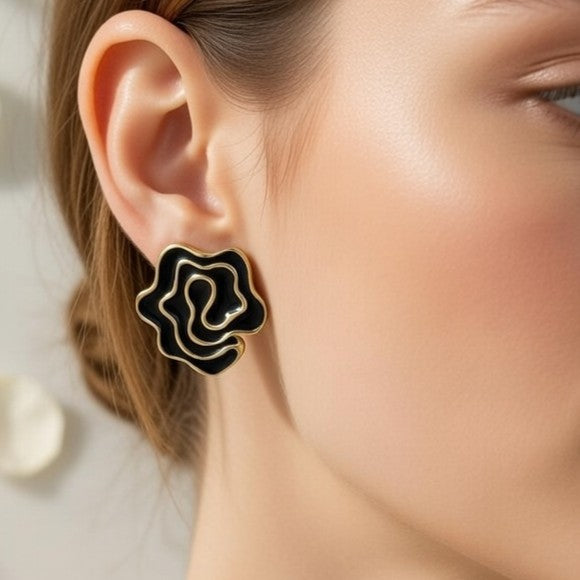 Detailed close-up of swirling black enamel rose studs